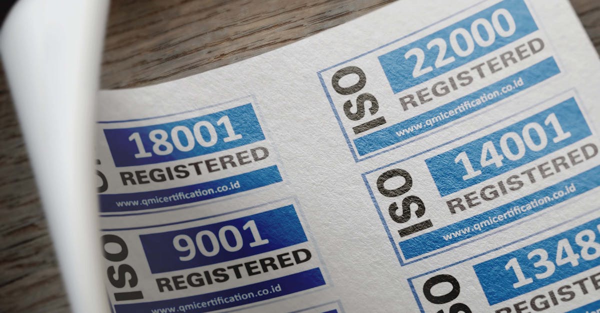 ISO certification stickers with registration numbers on paper.
